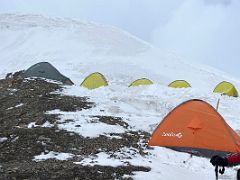 05B It snowed heavily overnight so we abandoned our yellow tent above and moved to the red one below at Yuhin Peak near Ak-Sai Travel Lenin Peak Camp 1 4400m