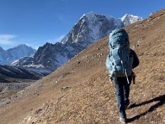 01B Lal Sing Tamang leads the way up the hill behind Lobuche with Kangtega, Thamserku, Taboche on the way to Lobuche East Base Camp