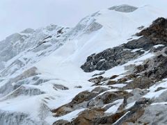 04C Two mountaineers are near the summit of Lobuche East Peak as we make our way to the last large rock blocking our way to the snow slopes