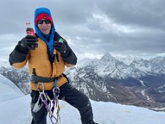 12B I enjoy a Coke and an energy gel on the Lobuche East Peak fore summit with Ama Dablam beyond