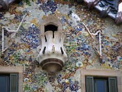 01C Casa Batllo has irregular oval windows and has a colourful mosaic made of broken ceramic tiles by Antoni Gaudi Barcelona Spain