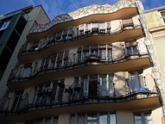 08A The rear view of the Casa Batllo has mosaic tiles at the top and wavy balconies Gaudi Barcelona Spain