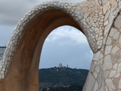 08E Tibidabo Amusement Park framed by Roof arch at La Pedrera Casa Mila Gaudi Barcelona Spain