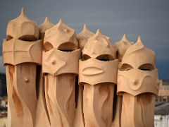 09A Four-stack chimney covered with lime and plaster looking like lines of warriors turned to stone Roof La Pedrera Casa Mila Gaudi Barcelona Spain