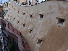 10B Looking down at the curved facade of the building and wrought-iron railings from Roof La Pedrera Casa Mila Gaudi Barcelona Spain