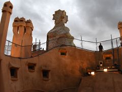 11D After sunset on ventilation chimneys and stairwell chimney covers Roof La Pedrera Casa Mila Gaudi Barcelona Spain