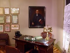 13B The Office with a wooden desk, a portrait of Pere Mila and framed documents on the wall Tenants Apartment La Pedrera Casa Mila Gaudi Barcelona Spain