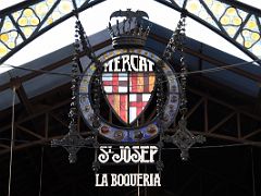 04B La Boqueria sign is cast iron and stained glass with Barcelona Coat of Arms and former Crown of Aragon with the bat as a heraldic symbol La Rambla Barcelona Spain