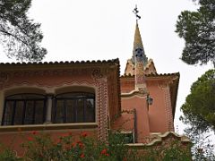 01C Gaudi House-Museum has a yellow and green spire and colourful chimney Park Guell Barcelona Spain