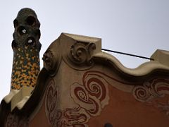 01D Gaudi House-Museum has a colourful green and yellow chimney covered with broken tiles Park Guell Barcelona Spain