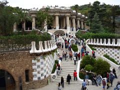 11A From the entrance esplanade a twin flight of steps soars up, flanked by two walls to the Hippostyle room Park Guell Barcelona Spain