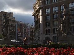 03A Statue of The Blacksmith (El Forjador) by Josep Llimona in 1914 and Woman with Boy by Josep Viladomat 1928 cradling a flute at waist level in Placa Catalunya Barcelona Spain