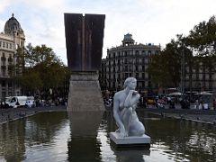 07 Deessa (Diosa, The Goddess) by Josep Clara 1909 A life size, white marble, seated figure of a nude woman on the north end of a shallow pool in Placa Catalunya Barcelona Spain