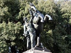 11 Sabiduria by Miquel and Llucia Osle 1929 depicts Minerva (wisdom) holding a horse crushing a snake, symbol of ignorance n Placa Catalunya Barcelona Spain