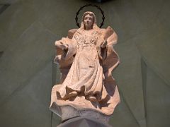 18B Virgin Mary statue is shown as a young woman before her marriage, with her hair down and a 12-star crown representing the 12 tribes of Israel Sagrada Familia Barcelona Spain