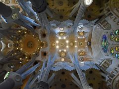 20B Tree trunk pillars lead to the ceiling with stained glass windows above Saint Joseph Sagrada Familia Barcelona Spain