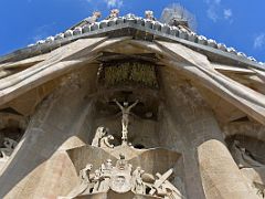 05D Crucifixion with ripped veil of the Temple of Jerusalem symbolizing the eras before and after Christ Passion facade Sagrada Familia Barcelona Spain