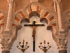 16B Statue of the crucifixion and Moorish arch inside the Villaviciosa Original Main Chapel close up Mezquita Mosque Cathedral Cordoba Spain