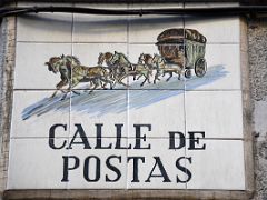 11 Calle de Postas has a horse-drawn carriage painted ceramic tile street sign Nearby Puerta del Sol Madrid Spain