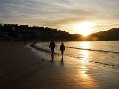 04B People Stroll On La Concha Beach At Sunset San Sebastian Donostia Spain