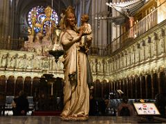 02A Virgin Blanca is a 13C stone figure of the Virgin with a kind smile with baby Jesus reaching out to caress his mothers chin Choir Toledo Cathedral Spain