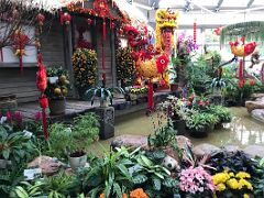 05A A colourful display in the Forsgate Conservatory of a traditional yellow dragon and fish costumes, plants, flowers in Hong Kong Park