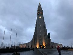 01A Hallgrimskirkja Church lit up in early morning view from the front with Leifur Eriksson statue below Reykjavik Iceland