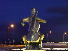 02B The Musician statue of Danish cellist Erling Blondal Bengtsson by sculptor Olof Palsdottir 1970 at night Harpa Concert Hall Reykjavik Iceland