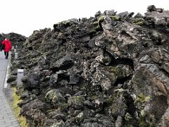 01B Walking up the path with a wall of black lava rocks on both sides Blue Lagoon geothermal spa Iceland