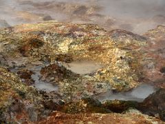 10B Very colourful red, green and yellow deposits on the ground with bubbling mud pots and hot steam fumaroles at Gunnuhver geothermal area Reykjanes Peninsula Iceland