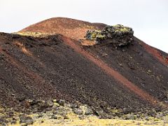 03C An eroded red crater with green moss covered black lava in Berserkjahraun lava field Snaefellsnes Peninsula Iceland