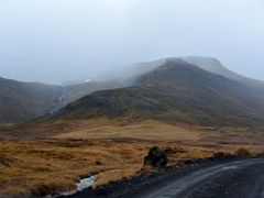 05 A narrow waterfall comes down off a hill next to dirt road 558 in Berserkjahraun lava field Snaefellsnes Peninsula Iceland