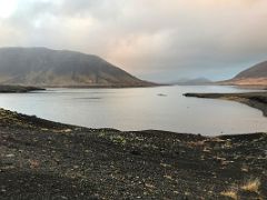 07 Seljafjordur inlet surrounded by black lava with ridge of Gjafi mountain beyond in Berserkjahraun lava field Snaefellsnes Peninsula Iceland