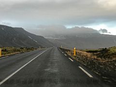 01A Driving thru green moss covered lava on road 574 with cloud covered mountains from Arnarstapi to the east Snaefellsnes Peninsula Iceland