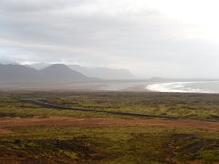 03A Road 574 snakes thru green moss covered lava with Hraunlandarif spit and Axlarhyrna mountain ahead from Raudfeldar canyon ravine on Snaefellsnes Peninsula Iceland