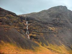 07B A narrow waterfall tumbles off the mountain above from Road 54 driving to the east on the south coast of Snaefellsnes Peninsula Iceland