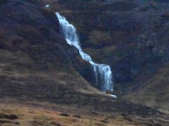 04A A waterfall tumbles off the rock cliffs of Ellidatindar next to Road 56 on Snaefellsnes Peninsula drive to Stykkisholmur Iceland