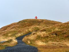 08B Steps snake up among the flowing grasses on top of the basalt island Sugandisey to the red lighthouse Stykkisholmur harbour Snaefellsnes Peninsula Iceland