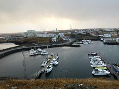 10A Looking down at the Stykkisholmur harbour, St Franciskuspitali Stykkisholmi Hospital and white Stykkisholmskirkja church from Sugandisey Cliff Snaefellsnes Peninsula Iceland