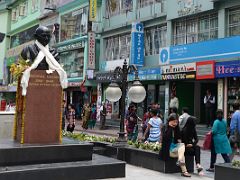 04B People Relax On Benches While Others Shop Next To Mahatma Gandi Bust Statue In MG Marg Shopping Area Of Gangtok Sikkim India