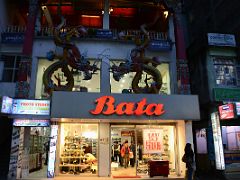 09B Sculptures of Colourful Oriental Dragons Adorn the Bata Shoe Store Building At Night at MG Marg Shopping Area Of Gangtok Sikkim India