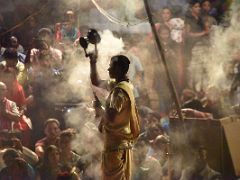 05B A Brahmin Rings A Bell And Waves Lamp Smoke In The Ganga Aarti Fire Ceremony On The Banks Of The Ganges Varanasi India