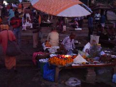 01C Pilgrims Mingle Near A Flower And Offering Seller Before Sunrise At Dashashwamedh Ghat On The Banks Of The Ganges River Varanasi India