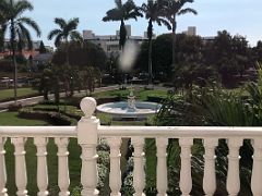 02C Looking out from the second floor of Devon House mansion to the expansive garden with a statue, fountain and trees Kingston Jamaica