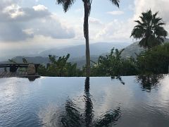 05B A palm tree is reflected in the infinity pool at Strawberry Hill Resort near Kingston Jamaica