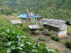 Kangchenjunga 09 02 Yamphudin House Outside The man who ran the campground at Omji Khola (2340m) recommended we stay at his house in Yamphudin (1690m). Here it is from the outside with very tall Buddhist…