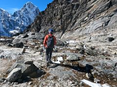 07B Trekking across the large wide rocks with Taboche and Cholatse beyond after climbing the scree slope on the way to Lobuche East Base Camp