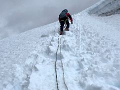 10A Guide Lal Sing Tamang leads the way up the steep snow slope on the Lobuche East Peak summit climb