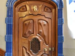 12B Decorative Carved Wooden Door surrounded by light blue tiles Casa Batllo Gaudi Barcelona Spain