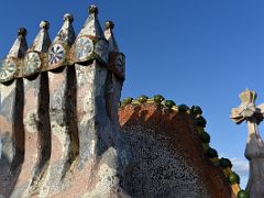 14B Four chimney stacks, a tower with a cross of four arms, the arched profile like the spine of a dragon Roof Terrace Casa Batllo Gaudi Barcelona Spain